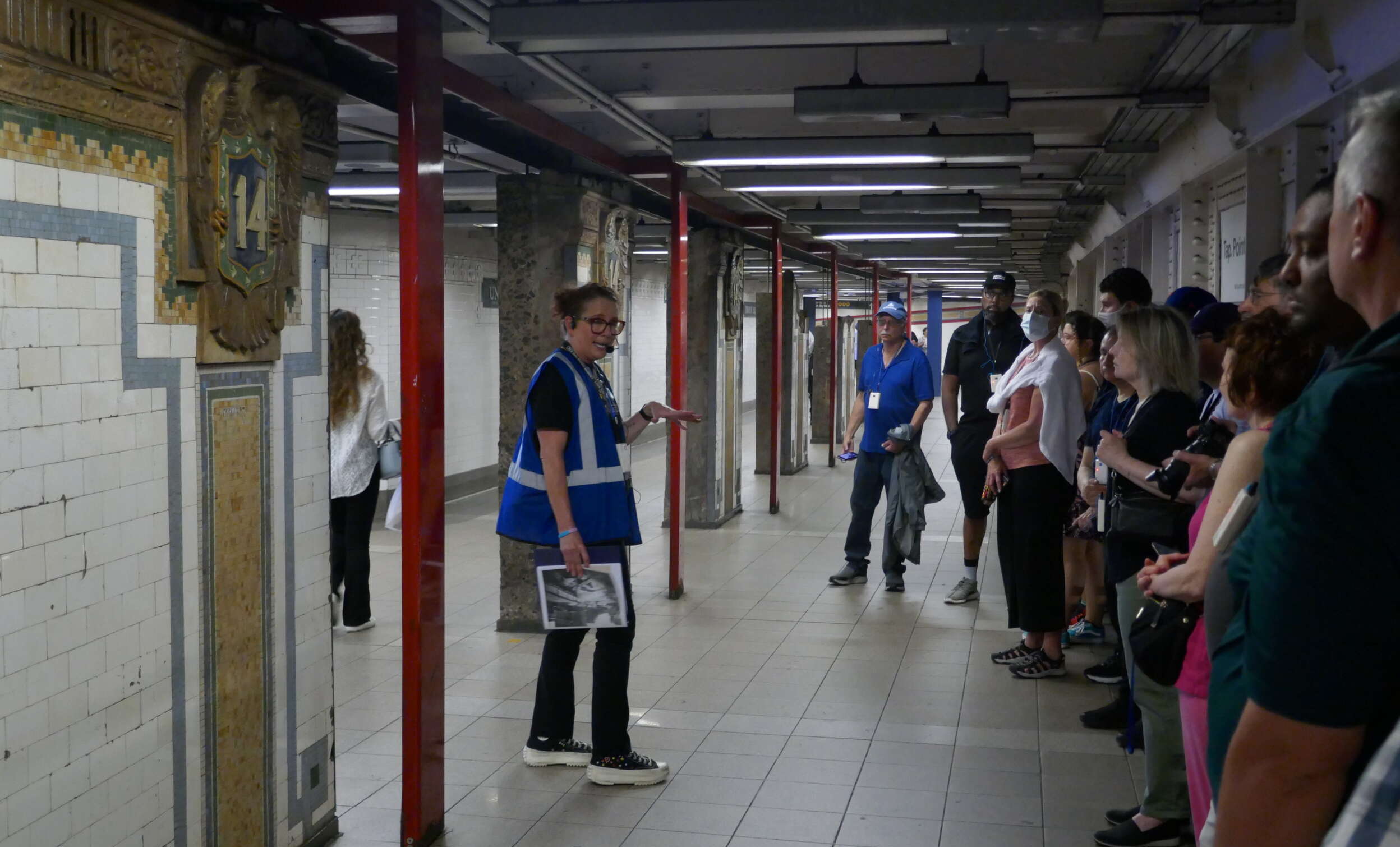 Tour Guide speaks to tour on subway mezzanine
