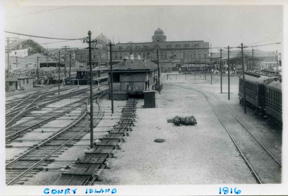 Train tracks terminate at Coney Island. Cyclone seen in back left. 1916.