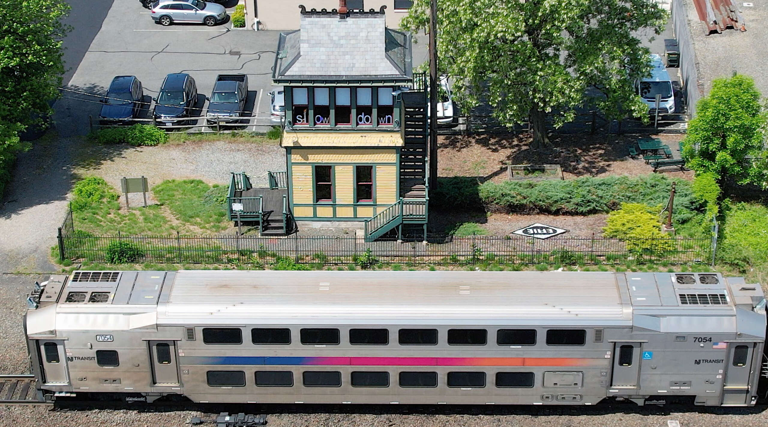 Aerial view of Waldwick Tower with installation in windows. NJ Transit train in foreground.