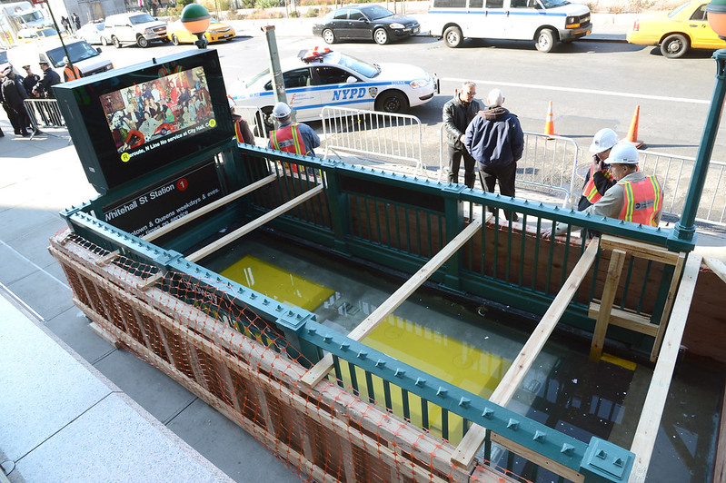 MTA workers test a removeable flood control cover at Whitehall St. Station.