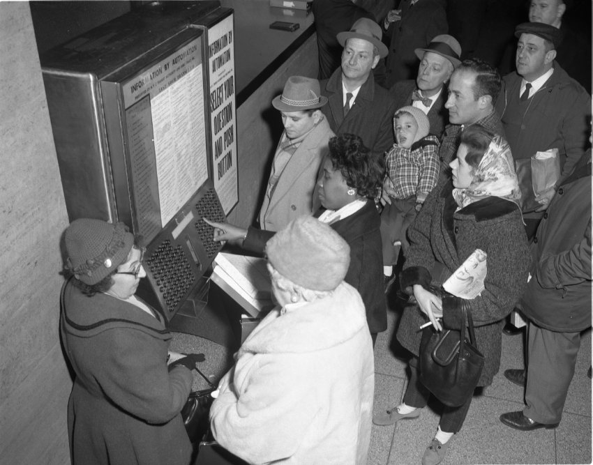 Transit customers look as woman demonstrated the Information by Automation machine.